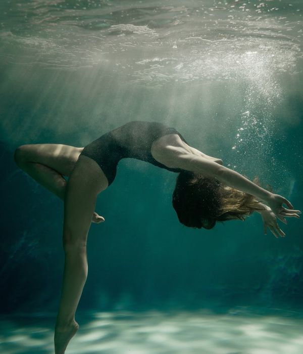 Woman in a fluid yoga flow pose, embodying grace and movement.